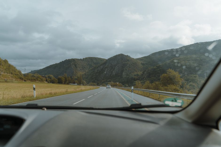 A serene drive through scenic mountain roads, showcasing picturesque views from a car window.